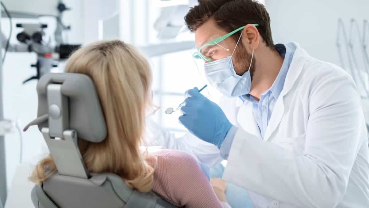 Patient receiving professional teeth whitening with a laser device Burton upon Trent
